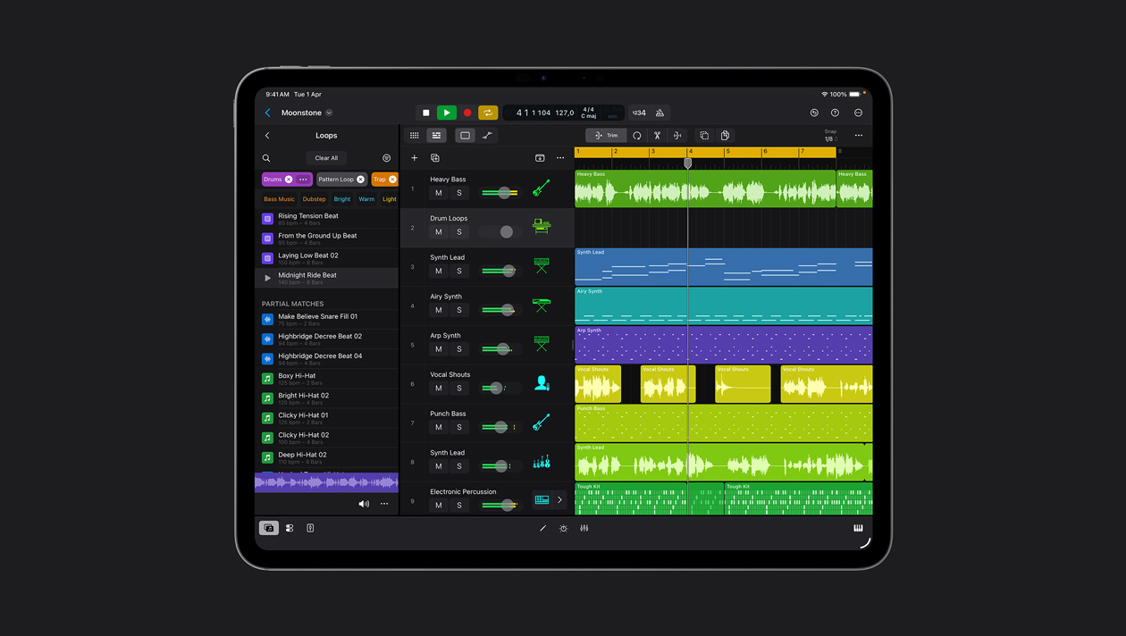 iPad Pro 13 screen showing Logic Pro workspace, Loops panel to the left, rows of sound waves in different colours