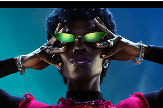 Colorful screen on a MacBook Pro of a person crowd-surfing at a party, showcasing the vibrant Liquid Retina XDR display